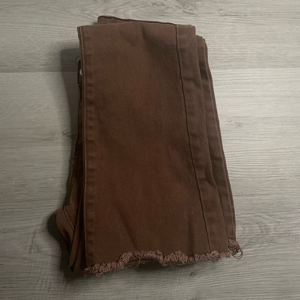 Brown flare jeans with frayed hem